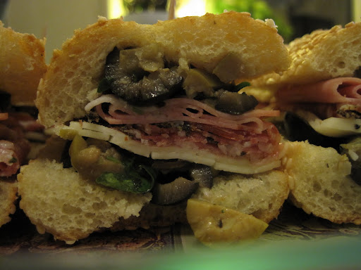 It's best to assemble the sandwich at least an hour before serving so the dressing in the olive salad soaks into the bread a bit.  I also made the salad the night before so the flavors would meld.