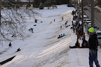 Sledding at the Pasfield Golf Course. Many cars line the sides of Lawrence Ave. on great sled days, like this one.