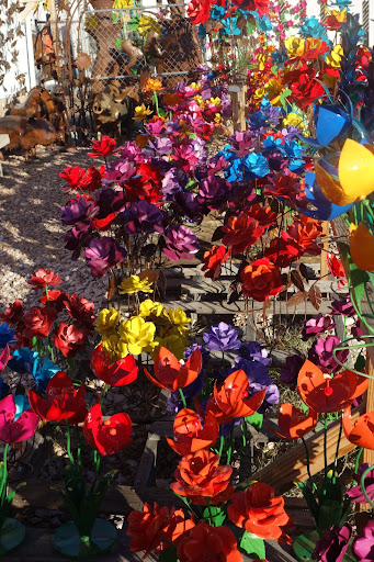 A garden of metal flowers seems almost lifelike in the morning light.