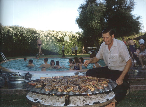 Summer isn't complete without a cookout by the pool. Garland of Garland Steel Company manning the grill at his pool party, Phoenix, Arizona, 1961. (Poolside With Slim Aarons, Abrams) Summer isn't complete without a cookout by the pool. Garland of Garland Steel Company manning the grill at his pool party, Phoenix, Arizona, 1961. (Poolside With Slim Aarons, Abrams)