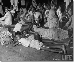 People waiting in railroad station trying to escape city after bloody rioting between Hindus and Muslims
