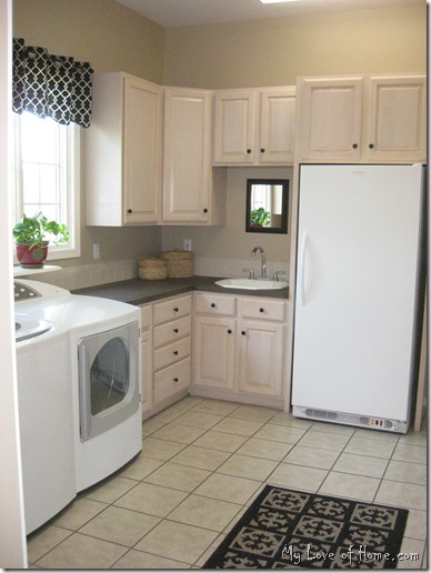 White freezer, brown counters, beige tile floor
