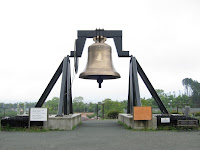 A bloody big bell. For scale, the signs on either side are about human height.