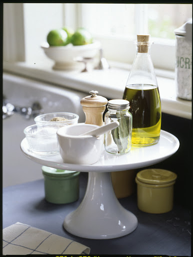 A simple cake stand on a kitchen counter can keep everyday essentials neat and within easy reach. A simple cake stand on a kitchen counter can keep everyday essentials neat and within easy reach.