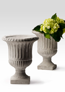 Heavy cement urn for fresh-flower arrangements.