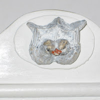 Detail of lovebirds on freestanding or wall hung wooden cupboard