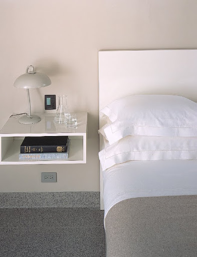 The pale-gray cotton sheets in the master bedroom typify Alexis's idea of luxury: simple, pure, and easy to live with.