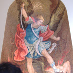 One guy with wings (an angel? Devil?) getting beat down by another guy with wings and a sword.