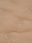 A close-up of a shimmery table linen from La Tavola. A close-up of a shimmery table linen from La Tavola.