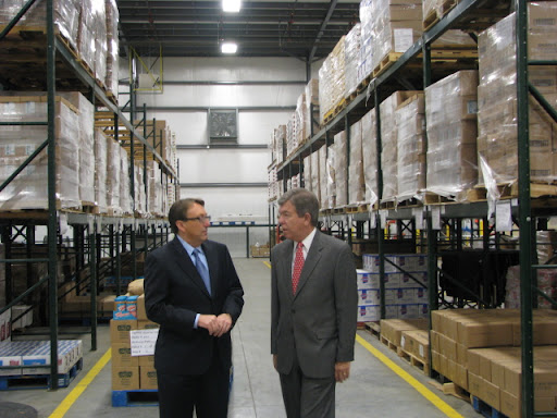 Brown gives Blunt a tour of the warehouse.