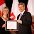 Stephen Harper confers the Award to Viara Dimitrova, Editor Bulagrain Flame with a Certificate of Achivement