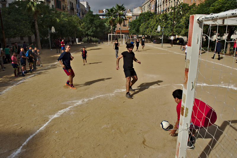 Playing footbal in one of the plazas from Barcelona, on a satuday afternoon. Although sometimes swarmed by tourists, the community life in Barcelona flows in it's own rithm.