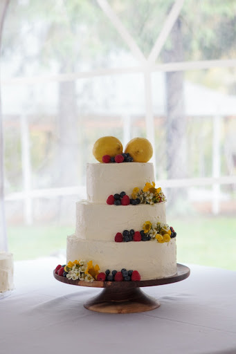 Our lemony angel-food cake was made using organic ingredients and decorated with fruit and a few teeny local blooms. The hand-turned salvage wood cakestand I found from the Wood Expressions Etsy shop.