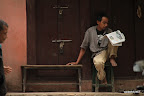 Reading the paper in the street