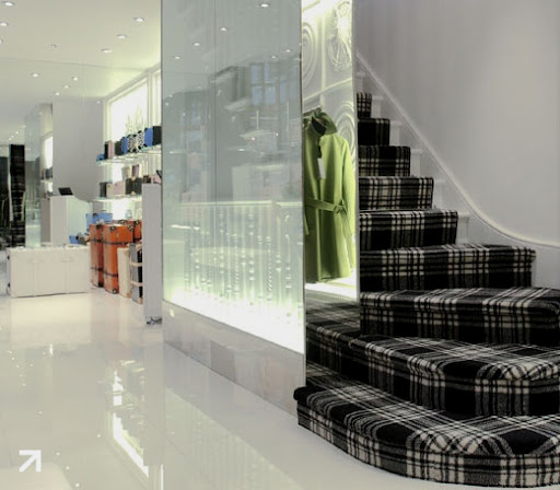 From Globe-Trotter's London shop -- the staircase is made up of gorgeous plaid carpet.