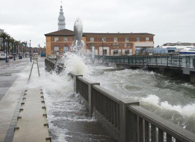 High tides by the Agriculture building in the Embarcadero in San Francisco splash onto the sidewalk. As climate changes progress, high tide events like this are predicted to become more common. Dave Rauenbuehler