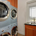 The laundry room features two washing machines and two dryers.