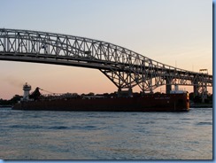 3727 Ontario Sarnia - Blue Water Bridge over St Clair River at sunset - Great Lakes Trader barge being pushed by the tug Joyce L. VanEnkevort