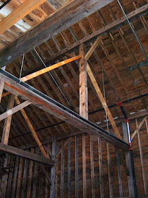 Purlin post are supported by two braces making it a king post truss.Which helps stop the tie beam from deflecting from the roof load.