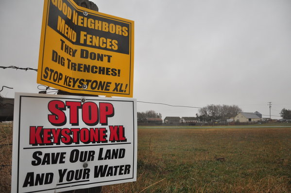 Signs are attached to a fence on the property of Jim Tarnick, a Nebraska farmer opposed to the Keystone XL pipeline project, 17 April 2013. Photo: Guillaume Meyer / AFP / Getty Images