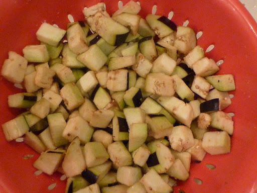 Eggplant draining in colander.
