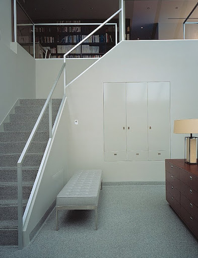 To enclose the staircase and balcony, the merest tracing of a handrail was constructed of anodized alumninum; the panels are filled in with especially clear, antireflective glass. To enclose the staircase and balcony, the merest tracing of a handrail was constructed of anodized alumninum; the panels are filled in with especially clear, antireflective glass.