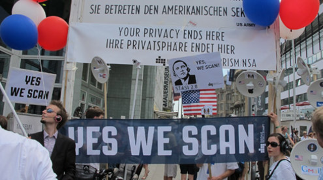Protestors greeted President Obama when he visited in June 2013. They are upset over the NSA spying. Signn read 'Yes We Scan'. Photo: Claudia Himmelreich / McClatchy