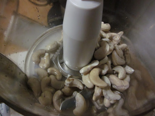 Drain the cashews and put them into your food processor with a couple ounces of water from the jar you just filled.  Process for about 15 seconds on high speed.