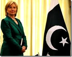 Hillary next to Black-War flag of Islam