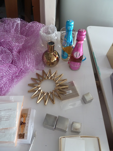 A random grouping of metallic items. Stainless steel cubes and a bud vase from Jayson Home and Garden. Pink and blue Nicholas Feuillatte Champagne minis.