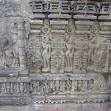 A goddess shown with eight hands, mostly broken except for lower two hands which are shown clasped together. Her mount, probably, is shown on left side but it seems tough to identify it clearly. It does not look like a lion, as it has big ears.