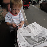 Reading the paper and waiting for a strong black coffee.