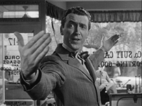 c0 Jimmy Stewart as George Baily had big dreams of seeing the world. Here he is showing how big he wants his suitcase to be. We all dream of seeing and doing wonderful things, but, like George, we never do. Hopefully, like George, we also realize everything we need is right here.