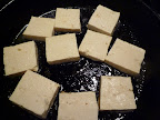 Tofu cooking in skillet