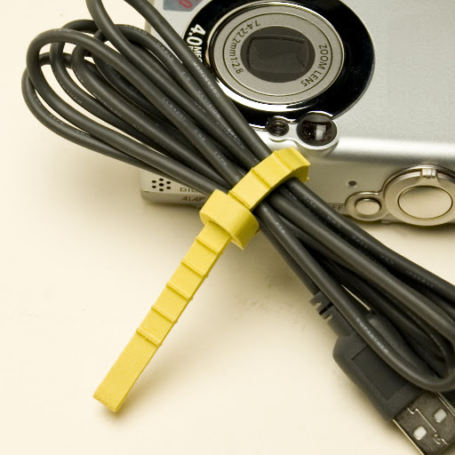 The original Q Knot works best to hold smaller items together, like this camera cord.