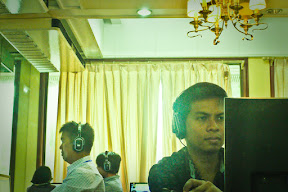 With other songwriters, producers, artists, and other musicians in the background