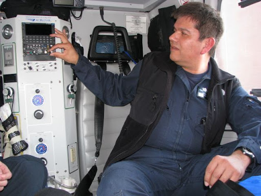 Flight paramedic Frank Perez adjusts the radio through which the flight crew communicates with emergency responders on the ground.
