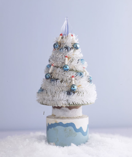 A three-and-a-half-inch tree -- first cousin to a cleaning brush -- has tiny ornaments and top that lights up. It was made in Japan, probably in the early 1950s for the dime-store market. A three-and-a-half-inch tree -- first cousin to a cleaning brush -- has tiny ornaments and top that lights up. It was made in Japan, probably in the early 1950s for the dime-store market.