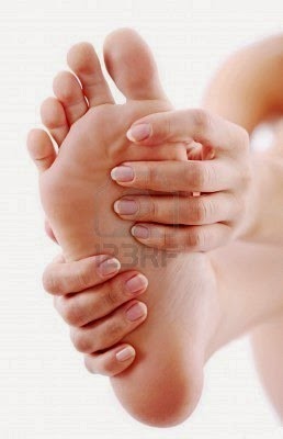 [6606763-young-woman-massages-her-foot-on-a-white-background%255B3%255D.jpg]