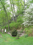 At the beginning of the main path through the garden. In the middle background, you can see the mysterious mist-spewing water feature in the rocks.