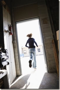 Woman running out door.