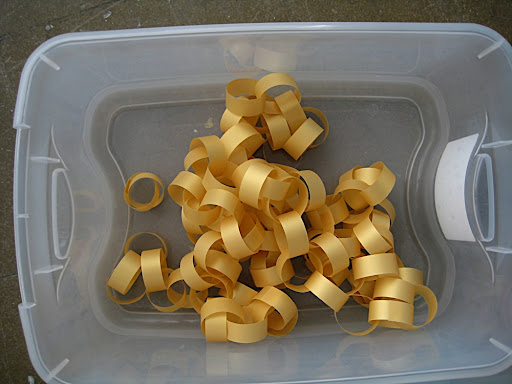 Golden curls of vellum paper chains.