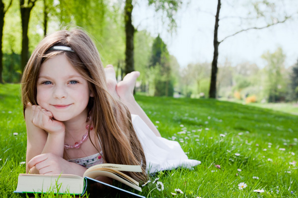 child-reading-book-outside.jpg Child reading book outside