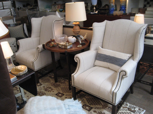 Two things I love about these wing chairs: alternation of vertical and horizontal lines and nail heads that enhance the unusual curves of the chairs form.