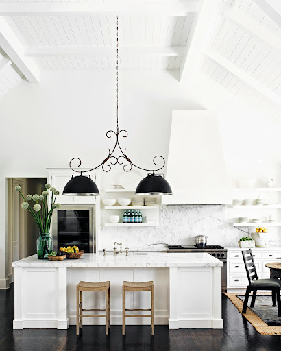This monochromatic kitchen is brought to life by the dramatic light fixture, made with a collection of found objects. This monochromatic kitchen is brought to life by the dramatic light fixture, made with a collection of found objects.