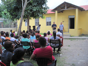 Pat telling the parents about school policies.