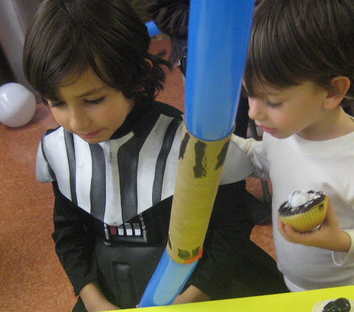 My little Darth Vader with his paper towel tube double-bladed light saber.