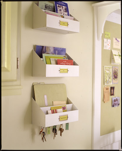 Wall mounted bins labeled with family members' names keep things from getting misplaced. Wall mounted bins labeled with family members' names keep things from getting misplaced.