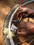 I thought this was pretty classically Africa, very well demonstrating both the pragmatic attitude of South Africans, as well as the sometimes unintended uses of the West's humanitarian donations. One boy was fixing the valve on his bicycle tire by using a condom as a gasket. I've heard that in some parts of Africa, people will actually use donated condoms as water containers, hauling several liters at a time with each condom! ;-) South Africa - 409.jpg