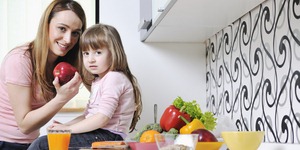 happy daughter and mom in kitchen